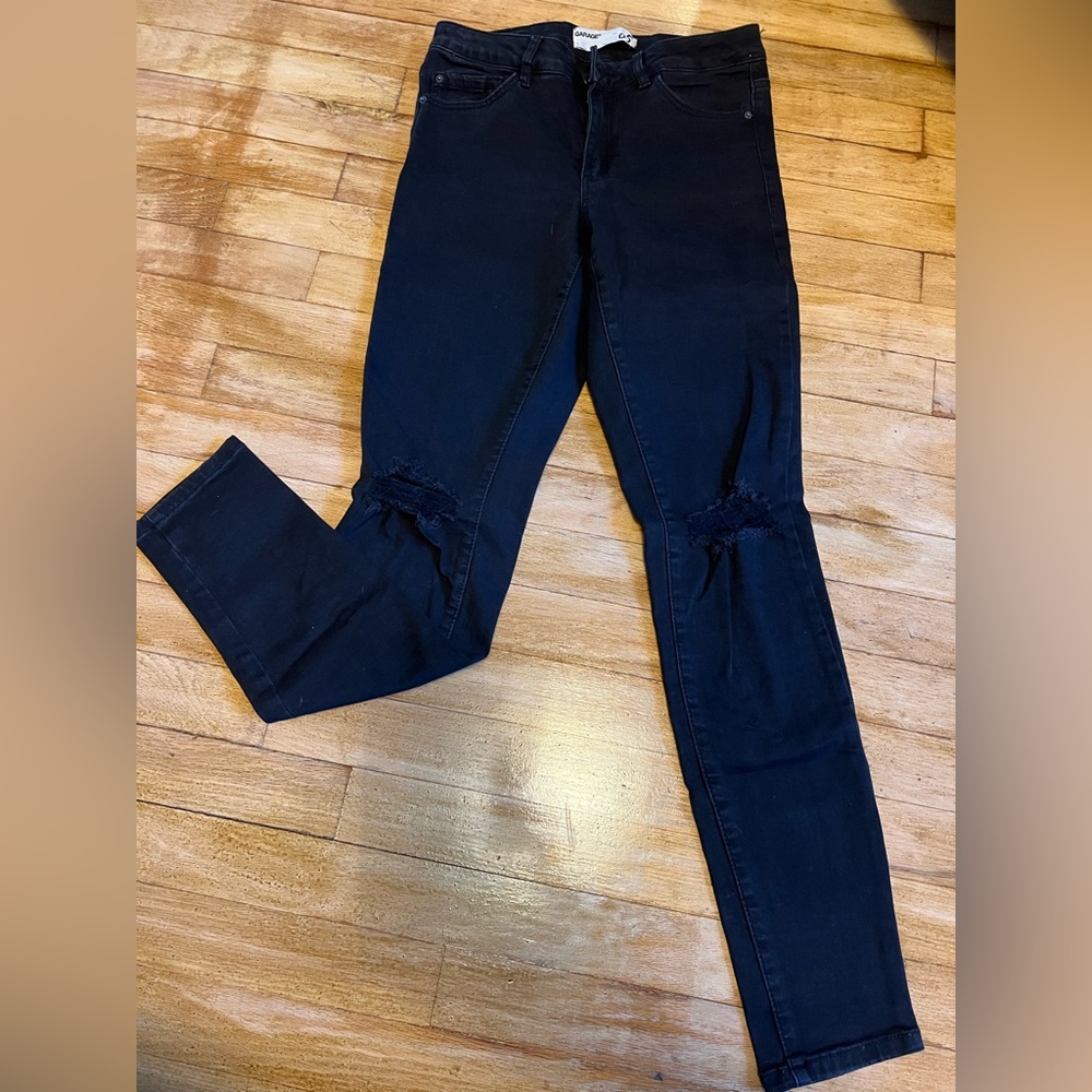 High-waisted black ripped jeggings. Super stretchy and stylish. Garage, size 6.